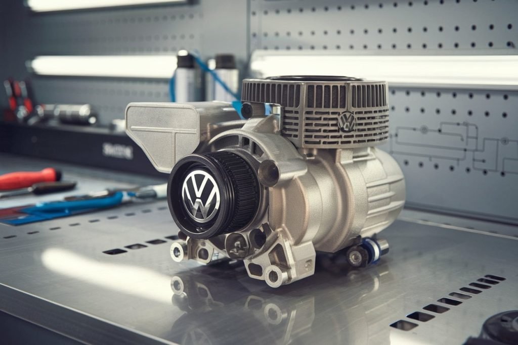 Volkswagen AC compressor inspected in the engine bay