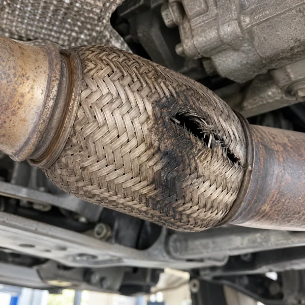 Cracked braided exhaust flex pipe beneath a Touareg
