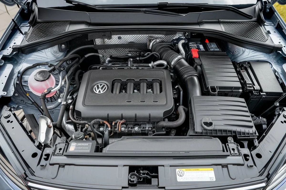 Volkswagen engine bay with a pink coolant reservoir on the left