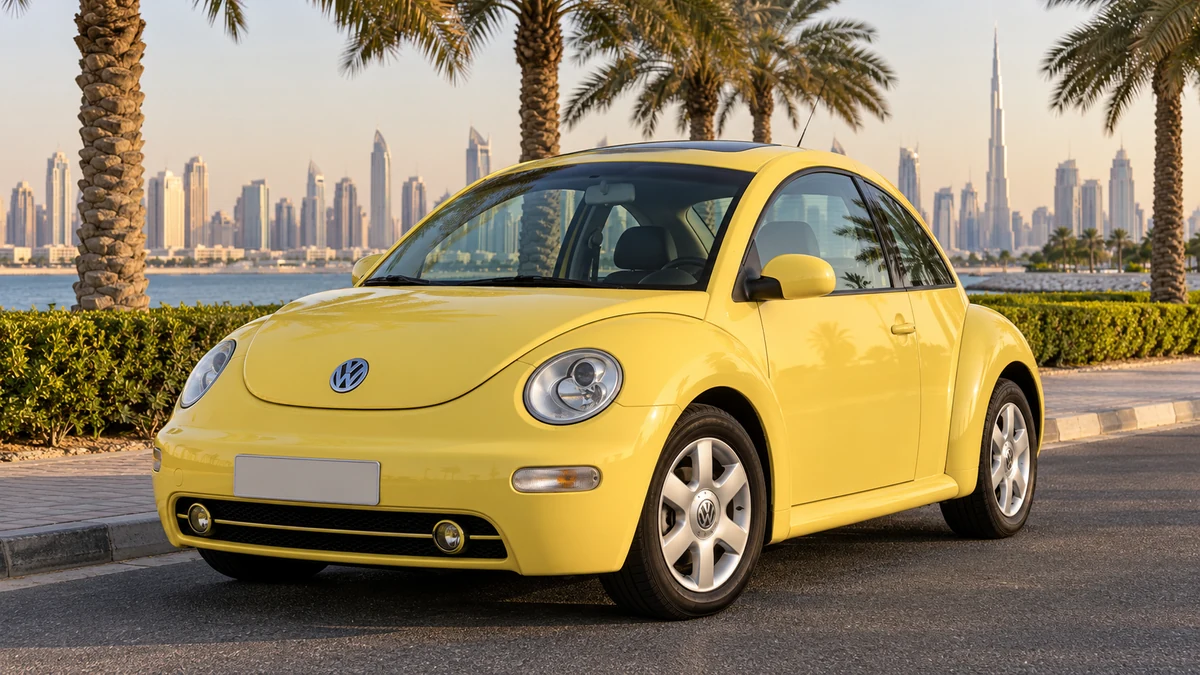 Yellow Volkswagen New Beetle beside a palm lined road